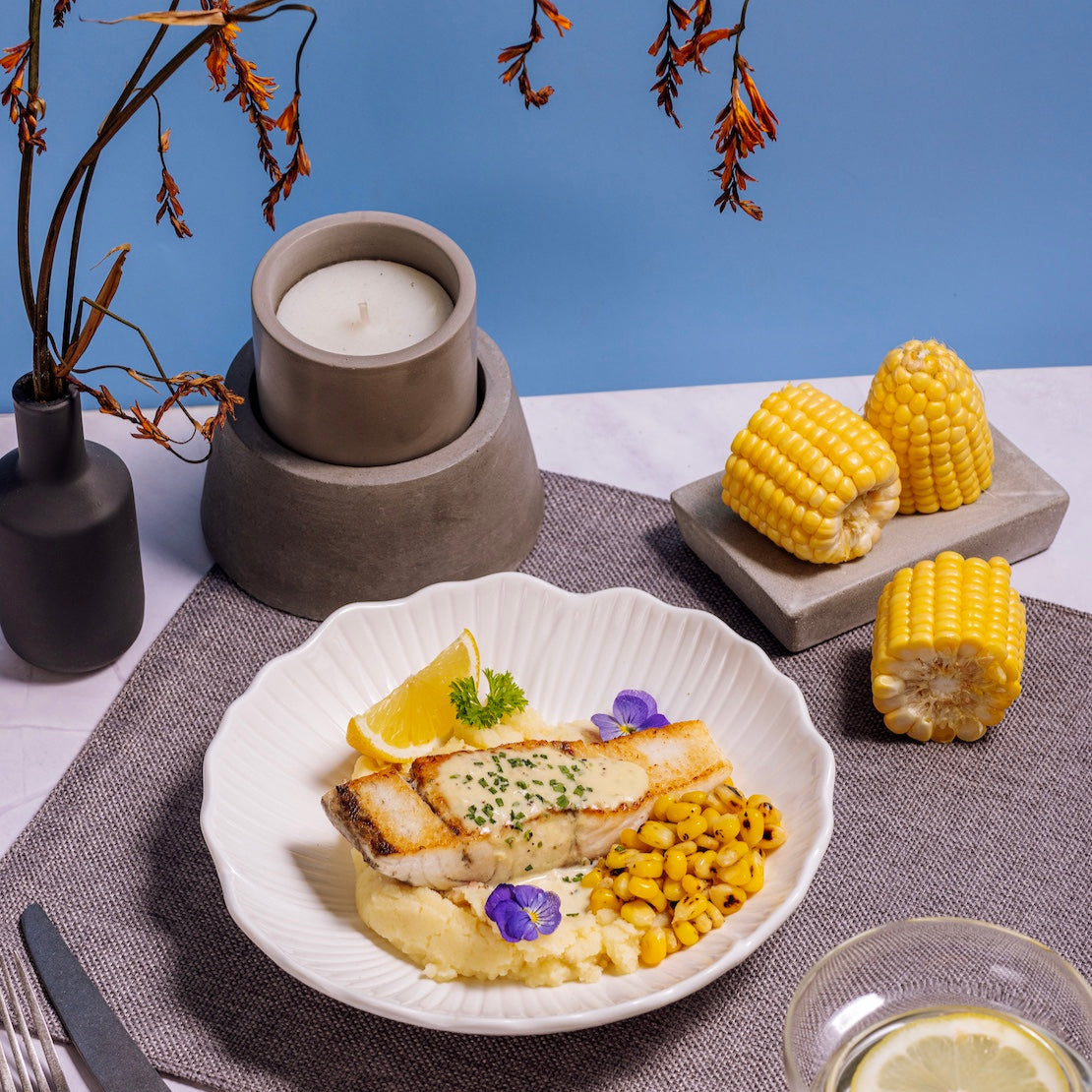 Garlic Cream Seabass with Truffle Potatoes & Grilled Corn